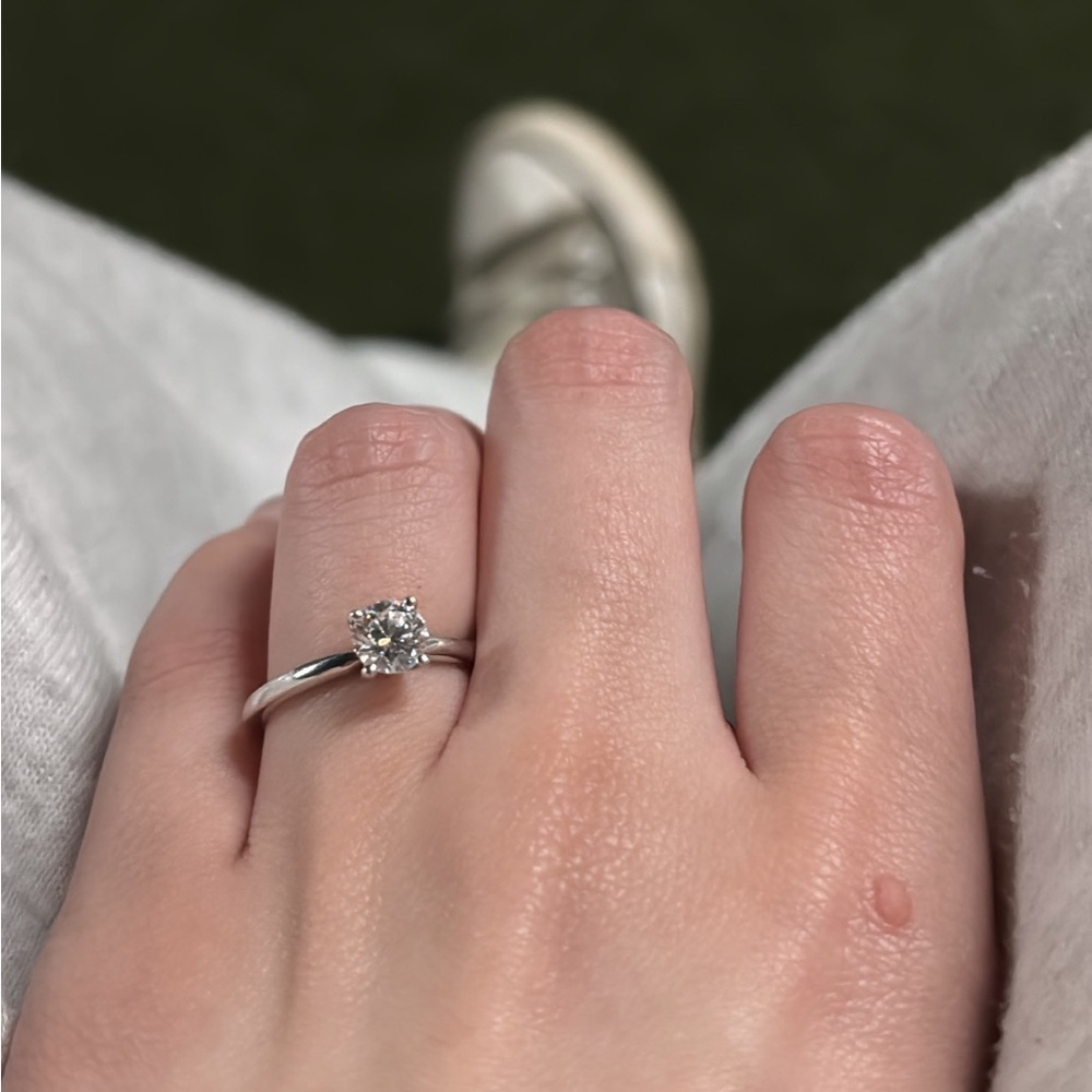 .71 carat round cut solitaire, 4 button prong simple ring.
